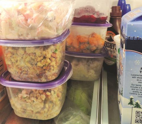 Plastic containers of leftovers stacked inside a fridge. Photo by Colorado State University Extension